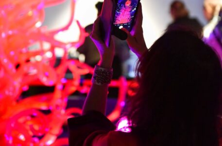 A visitor takes a photo in the Flame Gallery